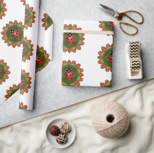 Red ladybug on red and green petals on white. wrapping paper
