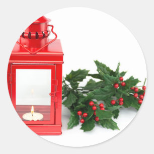 Red lantern with tealight holly twigs and berries classic round sticker