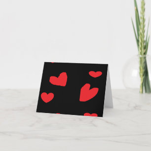 Red love hearts on black card