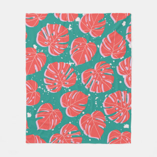 Red monstera leaves on green seamless pattern. Tre Fleece Blanket