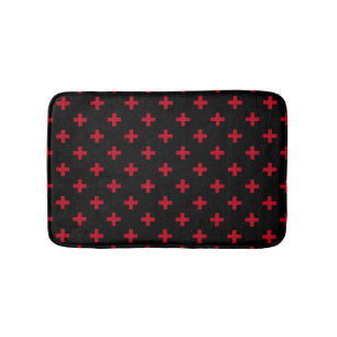 Red polka crosses on black bath mat