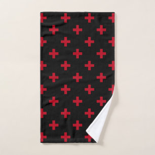 Red polka crosses on black hand towel