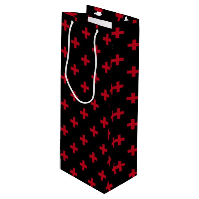 Red polka crosses on black wine gift bag (Front Angled)