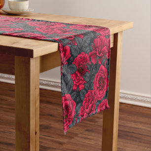 Red roses with grey leaves on black short table runner