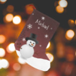 Red Snowman Winter Scene Christmas Stocking<br><div class="desc">Bring classic holiday cheer to your home with this Red Snowman Winter Scene Personalised Stocking. Featuring a charming snowman and top hat surrounded by falling snow and delicate white snowflakes, this design captures the magic of a snowy winter scene. Accented with festive holiday typography and a warm Merry Christmas greeting,...</div>