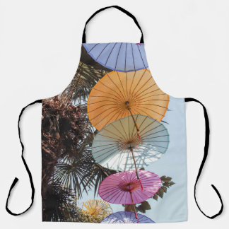 Red umbrella on green tree apron