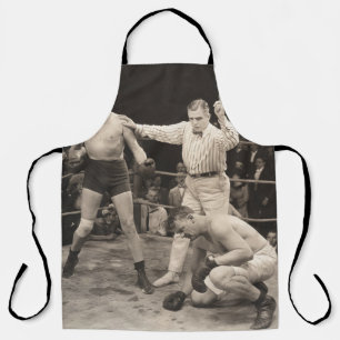Referee counting over boxer in ringboxing, vintage apron