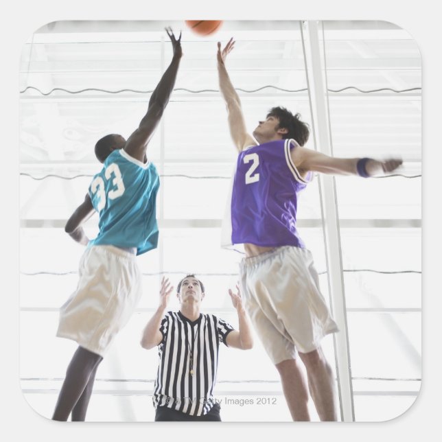 Referee watching basketball players jumping square sticker (Front)