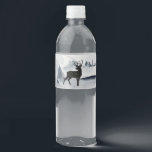 Reindeer in the Wild Grey Watercolor Christmas Water Bottle Label<br><div class="desc">Christmas water bottle labels with a watercolor image featuring a black silhouette reindeer standing among some pine trees. Grey black and white neutral colour scheme.</div>