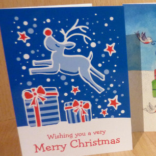 Reindeer prancing over gifts blue Christmas card