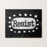 Resist Jigsaw Puzzle<br><div class="desc">Bold text reading "Resist" is centred against a black background. The black text sits on a white rectangle with large textured white dots around it, providing a playful contrast against the solid colour backdrop.</div>