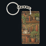 Retro book lover art key ring<br><div class="desc">A cozy retro-inspired design featuring a charming bookshelf filled with vintage books,  delicate botanical accents,   and a comforting cup of tea or coffee.</div>