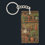 Retro book lover art key ring<br><div class="desc">A cozy retro-inspired design featuring a charming bookshelf filled with vintage books,  delicate botanical accents,   and a comforting cup of tea or coffee.</div>