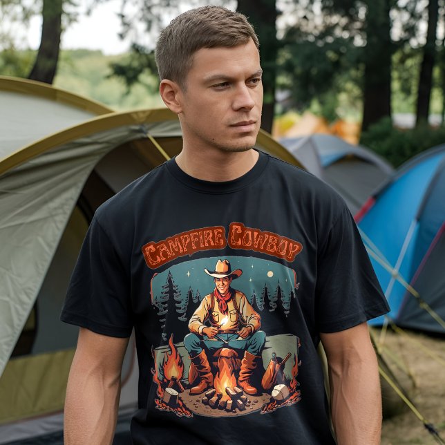 Retro Campfire Cowboy Western Grpahic T-Shirt (A man wearing a black t-shirt with a "Campfire Cowboy" graphic design, standing in front of a camp)