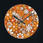 Retro Garden Floral 60s 70s Pattern Brown & Orange Round Clock<br><div class="desc">Retro Garden Groovy Floral Cheerful 60s 70s Pattern in 1970s Orange Brown Beige. Upbeat,  vivid,  vintage aesthetic flowers with a 1960s 1970s hippie flower power vibe. By Kierkegaard Design Studio.</div>