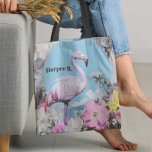 Retro Pink Flamingo Collage Tote Bag<br><div class="desc">This retro-inspired design features a bold, pastel-pink flamingo set against a bright blue backdrop, creating a serene yet striking contrast. Surrounding the flamingo, delicate flowers in shades of pink, yellow, and white evoke a dreamy, vintage garden feel, blending nature and pop art effortlessly. Perfect for lovers of quirky, feminine designs,...</div>
