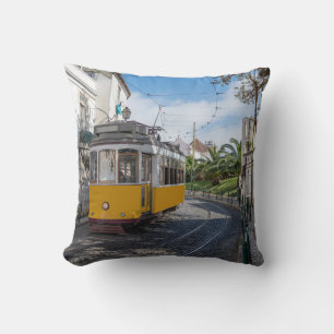 Retro yellow tram on street in Lisbon, Portugal Cushion