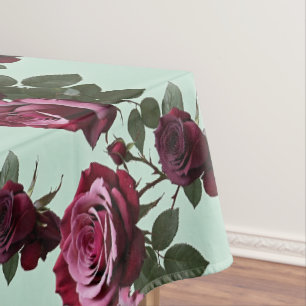 Rich Purple And Deep Red Roses On A Mint Green Tablecloth