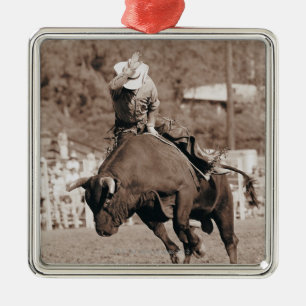 Rider about to fall off bucking bull metal tree decoration
