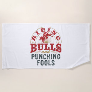 Riding Bulls and Punching Fools Beach Towel