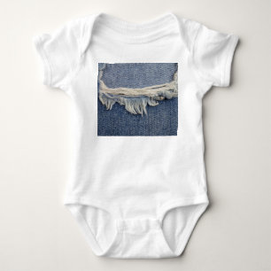 Ripped jeans texture, stylish background. baby bodysuit