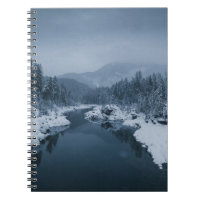 RIVER SURROUNDED BY SNOW COVERED FIELD WITH PINE T