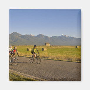 Road bicyclists ride down a back country road magnet