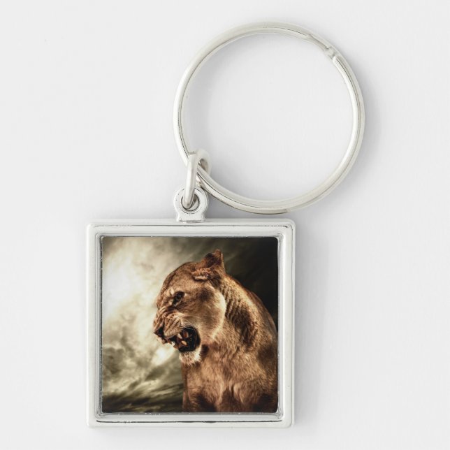 Roaring lioness against stormy sky key ring (Front)