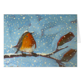 robin on branch on snowy day