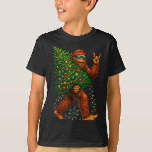 Rockin Christmas Bigfoot Carrying Tree Fun Xmas Ro T-Shirt