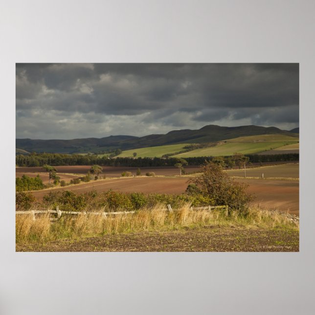 Rolling Hills And Mountains Under A Cloudy Sky Poster (Front)