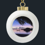 Romantic Maldives Tropical Sunset Ceramic Ball Christmas Ornament<br><div class="desc">This beautiful round ornament is decorated with a sunset image of Maldives in one of the remote islands with a palm tree in the foreground. There is a row of water bungalows and a gondola in the background bathing in the glow of the setting sun.</div>