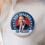 Ron DeSantis for President 2024 - Campaign Photo 6 Cm Round Badge<br><div class="desc">A rendering of Ron DeSantis with a ray of red light behind his head and type surrounding the photo. A simple design featuring Ron DeSantis running for President. He is running in the Republican primary for the 2024 election.</div>