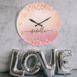 Rose gold blush pink glitter dust name script large clock<br><div class="desc">A rose gold and blush pink gradient background, decorated with faux glitter dust. Golden numbers. Personalise and add a name. The name is written with a modern hand lettered style script with swashes. To keep the swashes only delete the sample name, leave the spaces or emoji's in front and after...</div>