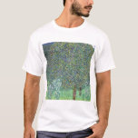 Rosebushes Under The Trees, Gustav Klimt T-Shirt<br><div class="desc">Gustav Klimt (July 14, 1862 – February 6, 1918) was an Austrian symbolist painter and one of the most prominent members of the Vienna Secession movement. Klimt is noted for his paintings, murals, sketches, and other objets d'art. In addition to his figurative works, which include allegories and portraits, he painted...</div>