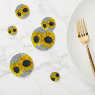 Round ball decor holds yellow sunflowers together confetti