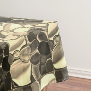 Rounded shapes in bronze colour, glossy light gold tablecloth