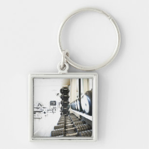 Row of free weights in foreground and exercise key ring