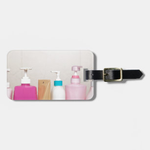 Row of toiletry bottles luggage tag