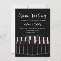 Row of wine glasses with red wine on black.