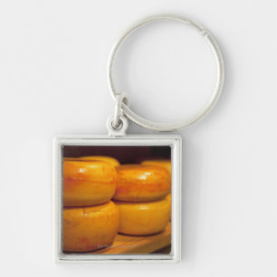 rows of colourful yellow Edam cheeses lined up Key Ring