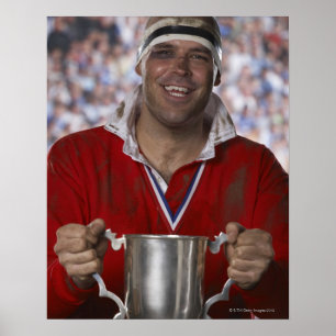 Rugby player holding trophy cup, portrait poster
