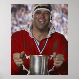 Rugby player holding trophy cup, portrait poster
