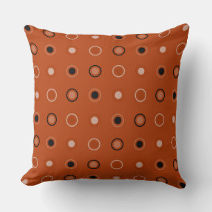 Rust, black, and white dots cushion