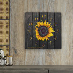 Rustic barn wood sunflower family farmhouse<br><div class="desc">Rustic country style wall clock with a yellow gold sunflower over a dark brown barn wood background.               Personalise it with your family name and text!             It can be a beautiful keepsake gift for your family anniversary,  wedding,  couple shower,  housewarming.</div>