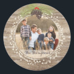 Rustic Christmas Pine Branch & Berries Wood Photo Classic Round Sticker<br><div class="desc">This rustic round Christmas sticker features a pine branch bough, berries and pinecones set against a warm brown wood background. Customise with a special photo and your family name (or delete). Perfect for a rustic, north woods, vintage look for your holiday envelopes or gift giving. Please check out our coordinating...</div>