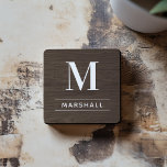 Rustic Dark Brown Wood Custom Monogram Initial Coaster<br><div class="desc">This simply elegant custom monogrammed beverage coaster set features classic white monogram text that can be personalised with a last name initial and last name. A beautiful keepsake gift for a newlywed couple, family, or new homeowners. A dark walnut brown faux wood grain background adds a rustic textured look to...</div>