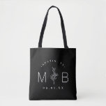 Rustic Floral Stem Wedding Monogram | Black Tote Bag<br><div class="desc">Custom printed tote bags make a fun and functional wedding favour your guests will love! Personalise the template with the bride and groom's names or monogram initials. Add your wedding date, the city, state or venue name or any other custom text. This modern rustic logo-style design has a simple floral...</div>