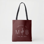 Rustic Floral Stem Wedding Monogram | Burgundy Tote Bag<br><div class="desc">Custom printed tote bags make a fun and functional wedding favour your guests will love! Personalise the template with the bride and groom's names or monogram initials. Add your wedding date, the city, state or venue name or any other custom text. This modern rustic logo-style design has a simple floral...</div>