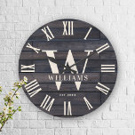 Rustic Monogram Farmhouse Custom Family Name Large Clock<br><div class="desc">Personalised Family Name, monogram, and year established Rustic Modern Wall clock in a trendy farmhouse style design with roman numeral clock face and dark brown black wood plank / shiplap backdrop design. Perfect gift for newlyweds, wedding or housewarming present or grandparents gift, or for a home make-over in your cabin,...</div>